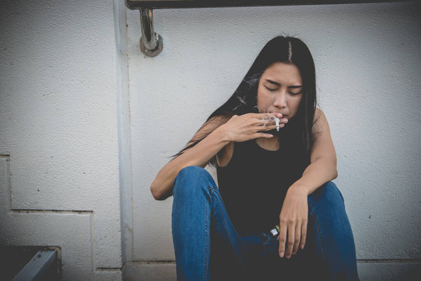 Asian woman sad from love,She smoking because stress from boyfriend,Heartbreak woman concept - Photo, Image