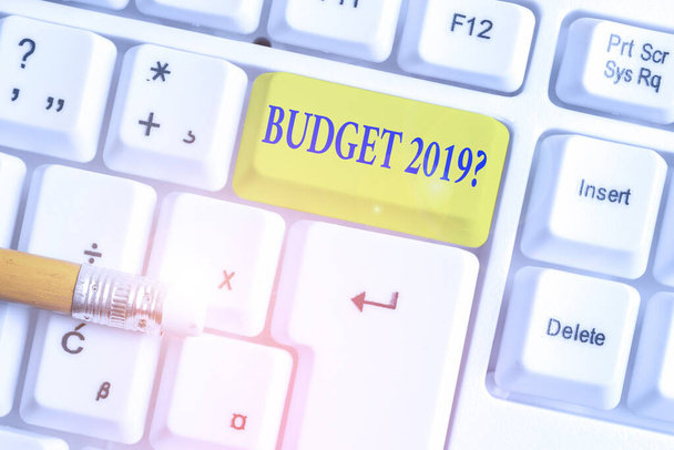 Writing note showing Budget 2019 Question. Business photo showcasing estimate of income and expenditure for next year White pc keyboard with note paper above the white background. - Photo, Image