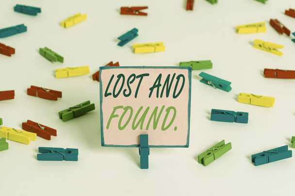 Text sign showing Lost And Found. Conceptual photo a place where lost items are stored until they reclaimed Colored clothespin papers empty reminder white floor background office. - Photo, Image