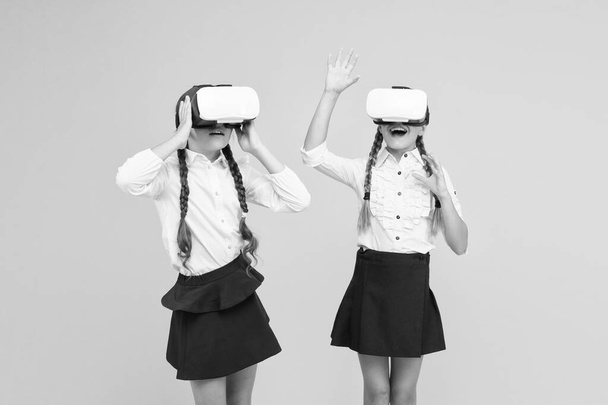 Enjoy new experience. Happy kids use modern technology. future education. back to school. Digital future and innovation. virtual reality. small girls in VR headset. children wear wireless VR glasses - Fotoğraf, Görsel