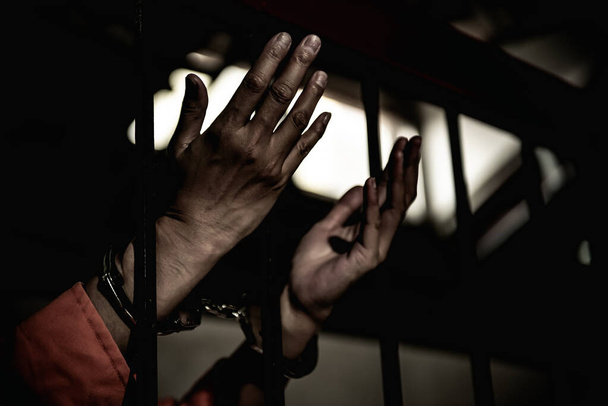 Hands of woman desperate to catch the iron prison,prisoner concept,thailand people,Hope to be free. - 写真・画像