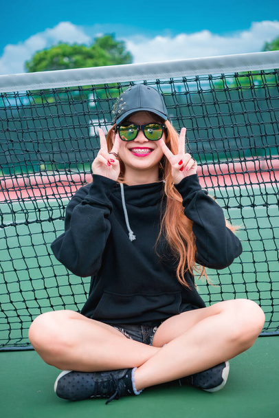 Cool Hipsters girl in black hood with black hat and black sunglass - Φωτογραφία, εικόνα