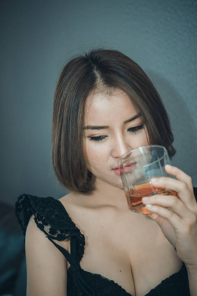 Asian woman broken heart with whiskey in hand on vintage style,she heart break from love,sad woman concept - Fotó, kép
