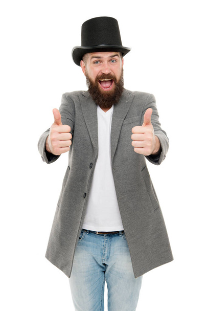 Thumbs up to retro. Bearded man wearing cylinder hat in retro style. Caucasian guy showing thumbs ups in retro tophat. Emotional hipster with mustache and beard in retro hat - Foto, Imagem