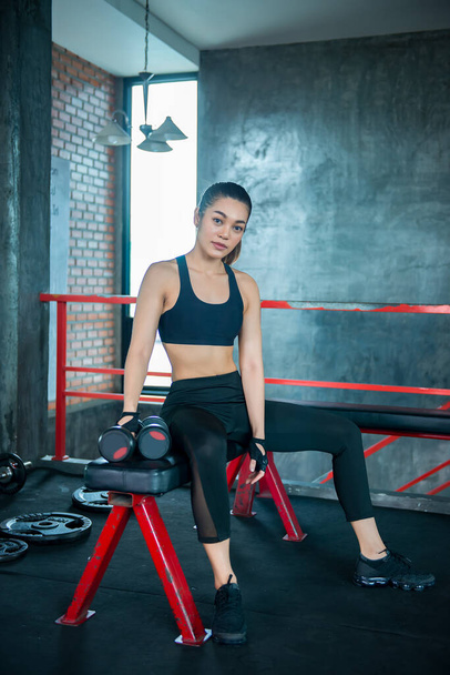 Close up asian beautiful sport girl on wall of gym,Thailand love health,Slim woman workout concept - Foto, Bild