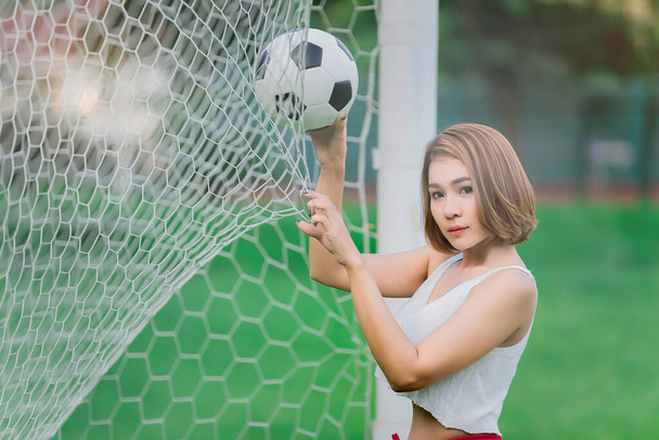 Portrait of sexy asian woman wear soccer player dress,World cup cheer ball concept,Thailand people,England fanclup - Photo, image