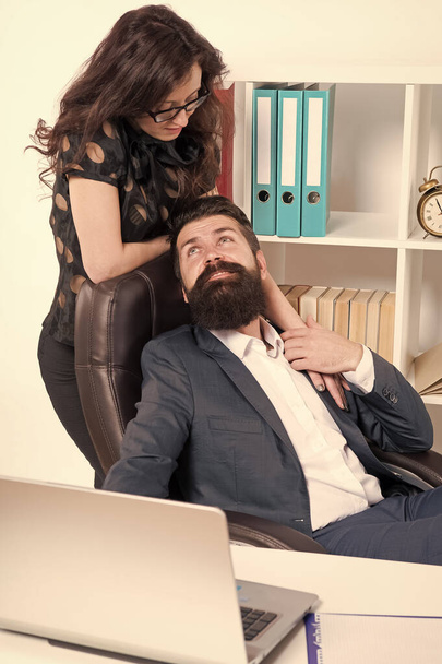 Love is everywhere. Love affair of businessman and sexy woman. Couple in love conducting affair at work. Boss and secretary having love relationship. Bearded man flirting with sensual woman in office - Photo, image