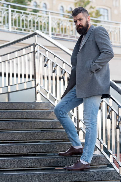 One step at a time. Beginning of working day. Motivated for success. Conquer business world. Office worker confidently step on stairs. Bearded business man going to work. Business man in modern city - Photo, Image