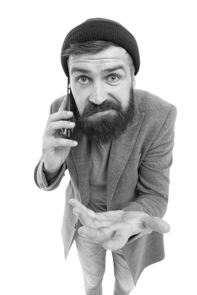 Say it with cell phone. Caucasian guy making a call with portable telephone or smartphone. Bearded man talking on mobile phone. Hipster using phone to talk on move - Zdjęcie, obraz