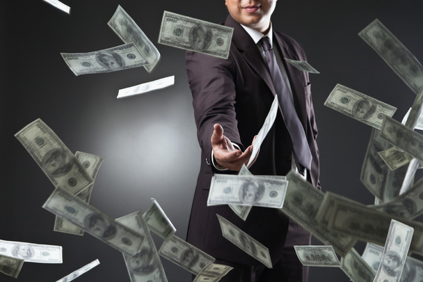 Handsome young man throwing money - Photo, Image