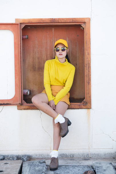 Portrait of beautiful asian woman in yellow cloths,Hipsters girl wear yellow hat  take a picture,Thailand people - Foto, Imagem