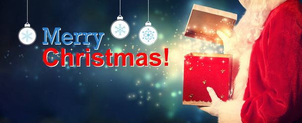 Merry Christmas message with Santa opening a gift box - Valokuva, kuva