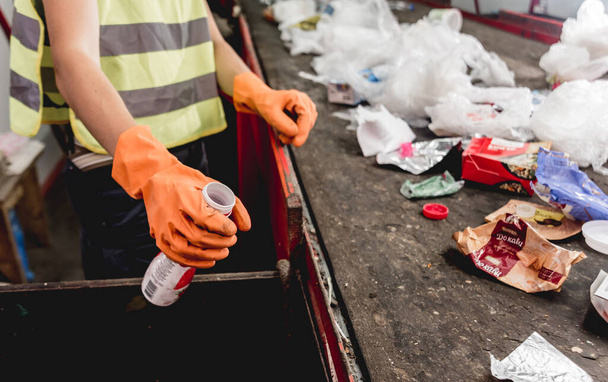 Worker separating garbage collection at modern recycling plant - Photo, Image