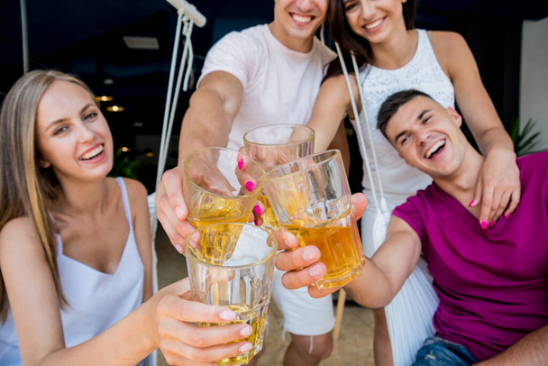 Cheerful friends in the pub. Drinking beer, talking, having fun. Meeting friends after work - Φωτογραφία, εικόνα