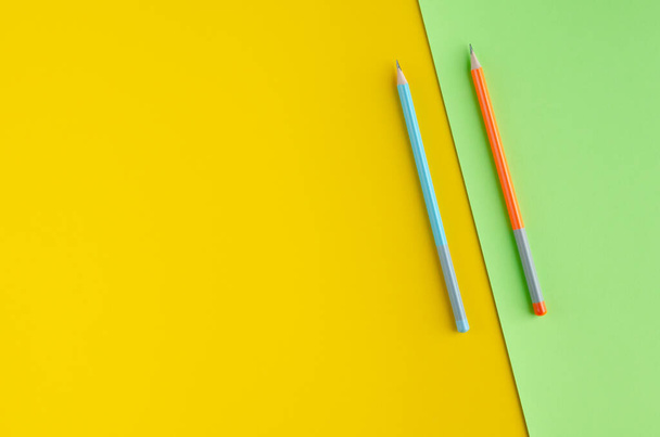Colored pencils composition on yellow and green background. - Foto, immagini