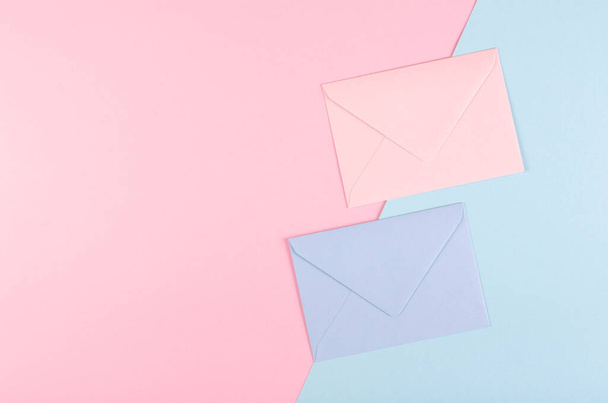 Blue paper envelope composition on pink background. - Photo, Image