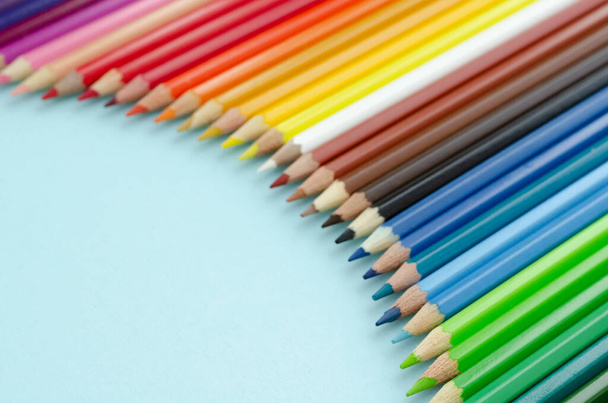 Colored pencils composition on blue background. Flat lay. - Photo, Image
