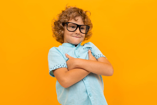little boy posing against orange background  - Фото, зображення