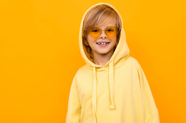 cute fashionable boy posing in yellow hoodie - Photo, image