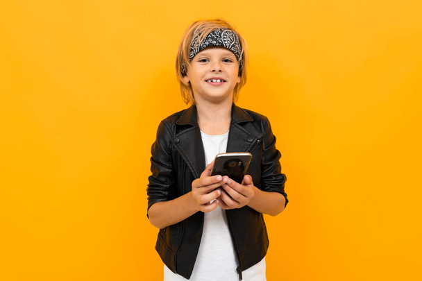 boy with smartphone against orange - Foto, Imagen