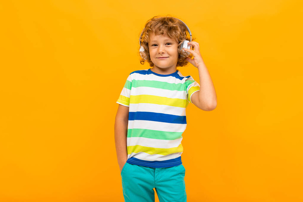 little boy posing against orange background  - Valokuva, kuva