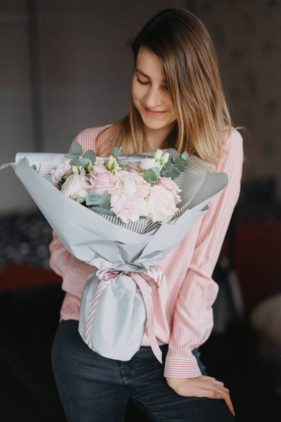 girl with a bouquet of flowers in her hands - Photo, image