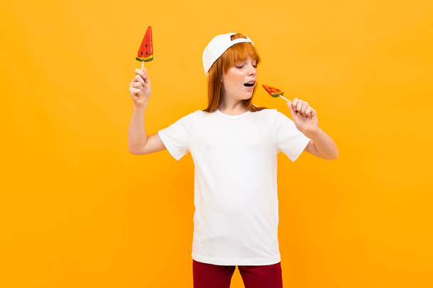 cute ginger girl with watermelon lolipops  - Photo, Image