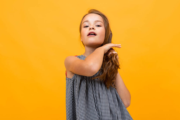 piękna mała dziewczynka pozowanie na pomarańczowym tle  - Zdjęcie, obraz