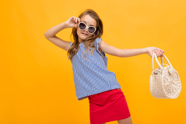 beautiful fashionable little girl posing against orange - Fotografie, Obrázek