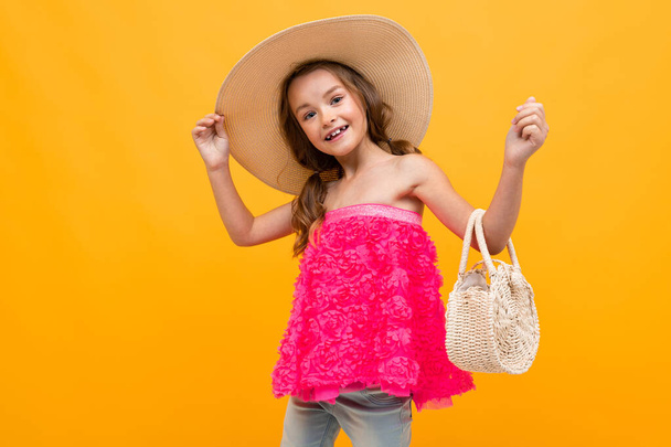 cute fashionable little girl posing against orange background  - Фото, зображення