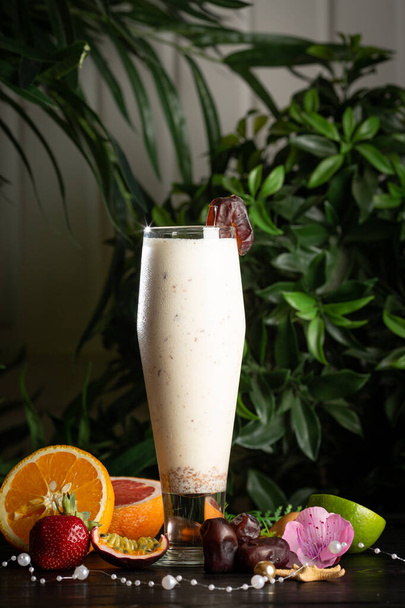 milkshake with a date in a glass and fruits - Zdjęcie, obraz