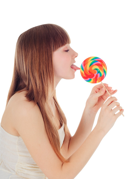 Pretty Young girl licking a lollipop - Photo, Image