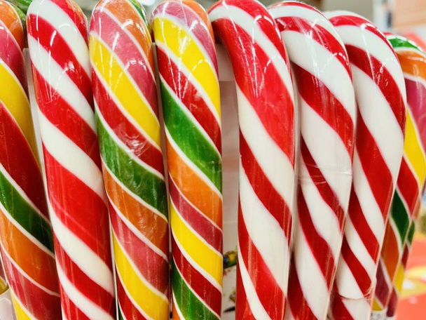 colorful candy canes in bucket in the shop. - Photo, Image