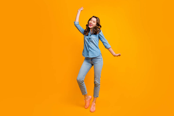 Full length body size photo of cheerful positive cute nice attractive pretty girl dancing with eyes closed while no one sees with hair curly wavy isolated vivid color background - Fotó, kép