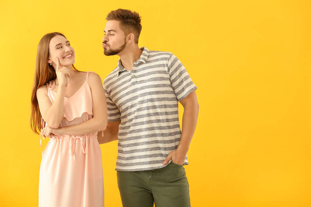 Portrait of funny young couple on color background - Photo, Image