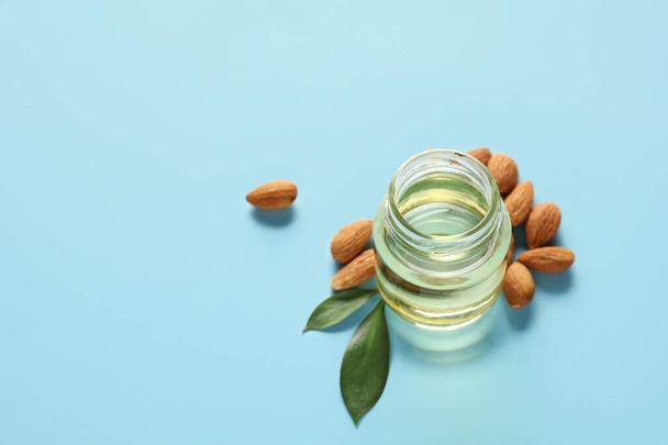 Jar of almond oil on color background - Photo, Image