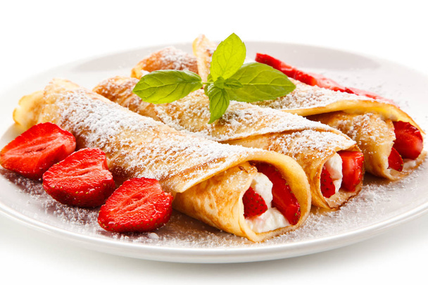 Crepes with strawberries and cream on white background  - Φωτογραφία, εικόνα
