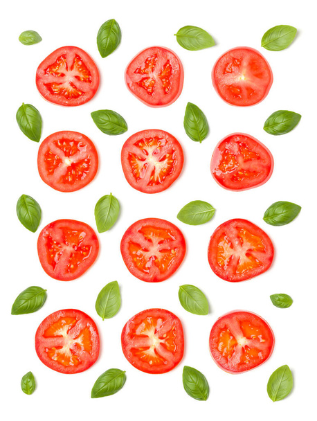 Creative layout made of tomato slices and basil leaves. Flat lay - Photo, Image