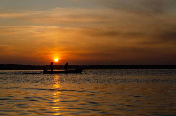 The fishermen and boat silhouette - Photo, image