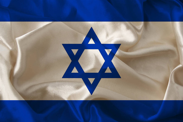 photo of the beautiful colored national flag of the modern state of Israel on textured fabric, concept of tourism, economics and politics, closeupof travel, economy and state policy - Photo, Image