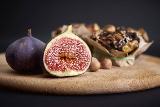 delicious fresh muffins and figs and hazel lie on the board - Photo, Image