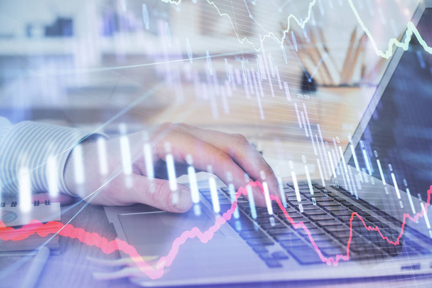 Double exposure of mans hands writing notes with laptop of stock market with forex graph background. Top View. Concept of research and trading. - Valokuva, kuva