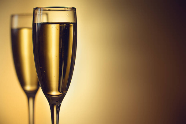 Two glasses of champagne on a blurred background. Celebration concept. Selective focus. Background with copy space. - Foto, imagen