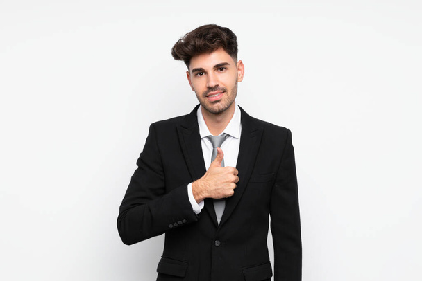 Young businessman over isolated white background giving a thumbs up gesture - Photo, Image