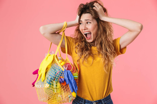 Photo of scared shocked woman holding bag with plastic waste - Foto, Imagem