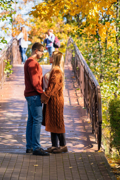 Young couple in love walking in an autumn park - Фото, изображение