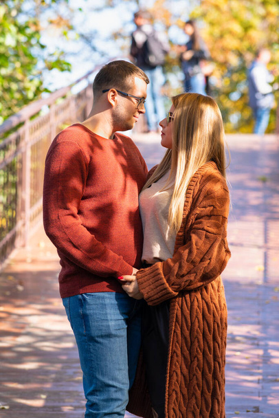 Young couple in love outdoors in an autumn park - Fotó, kép