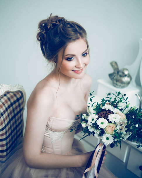 beautiful young woman bride with wedding bouquet. - Фото, изображение