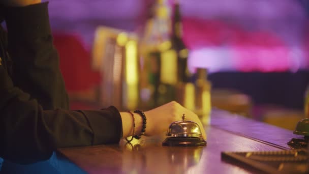 A person rings the bell on the bartender stand several times - bartender putting the drink on the stand - Filmmaterial, Video