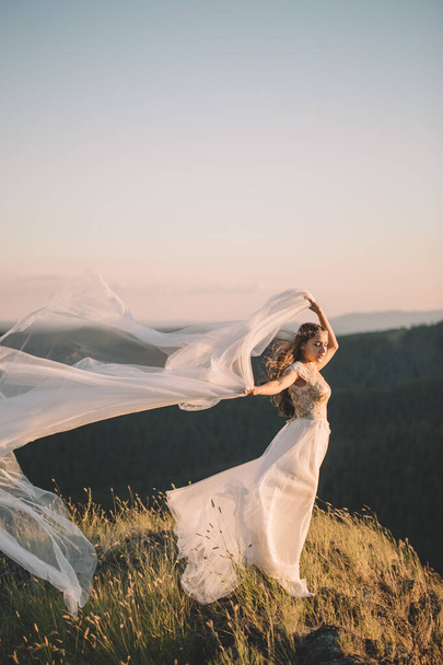Beautiful bride outdoors in a forest. - Fotoğraf, Görsel